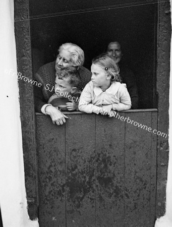 MOTHER AND CHILDREN AT COTTAGE HALF-DOOR